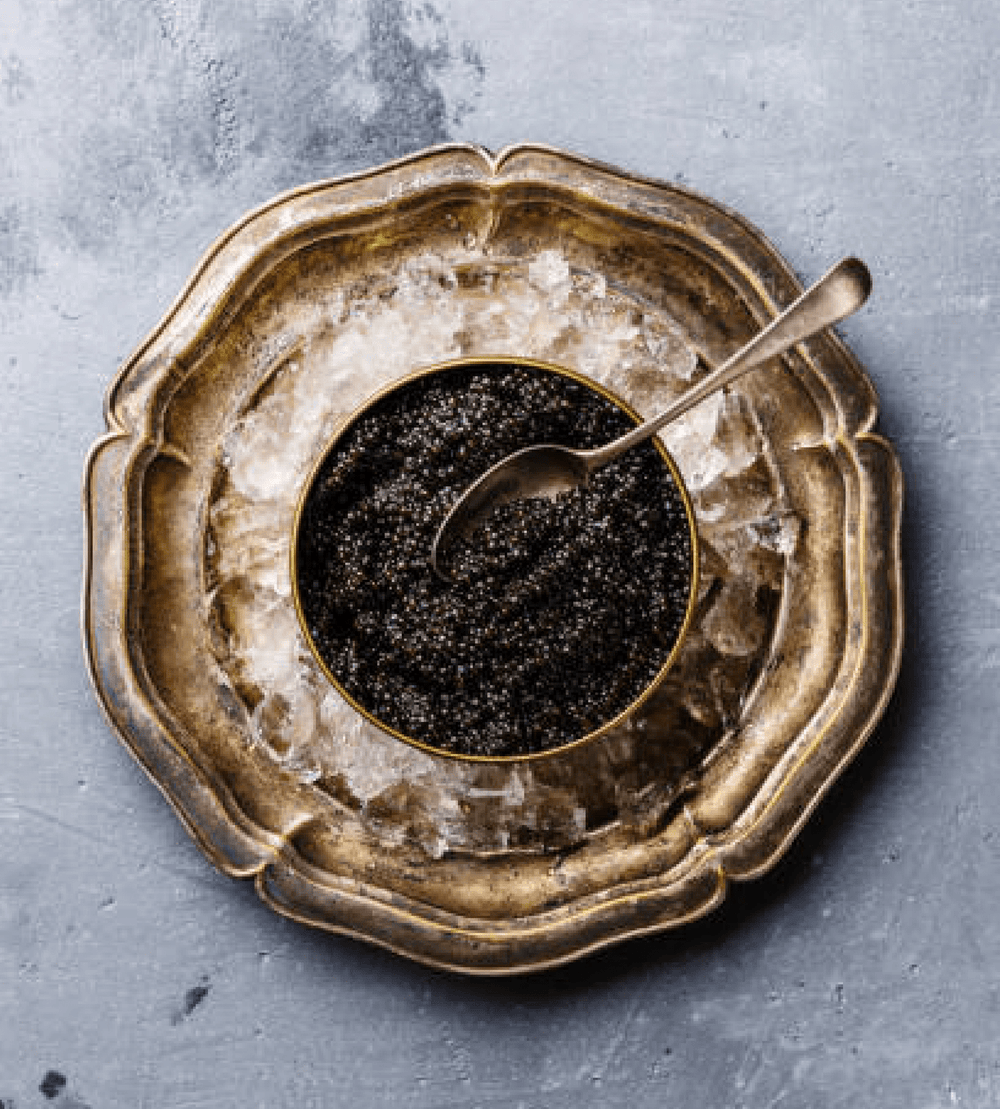 How can you spark up traditional serving of black caviar?